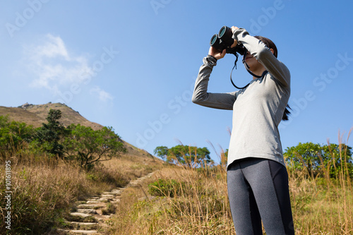 Girl with binoculars at hill