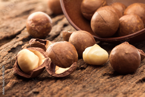 Close up macadamia nuts on wooden plate photo