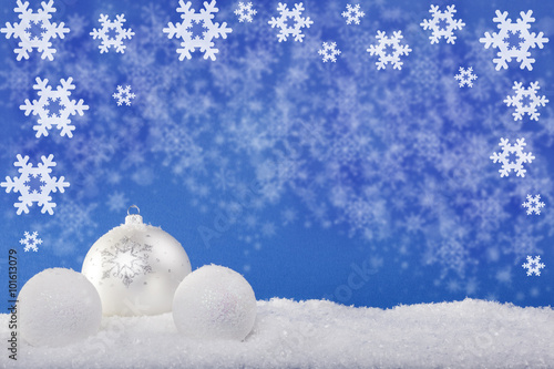white Christmas balls in the snow