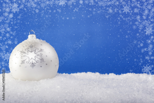 white Christmas balls in the snow