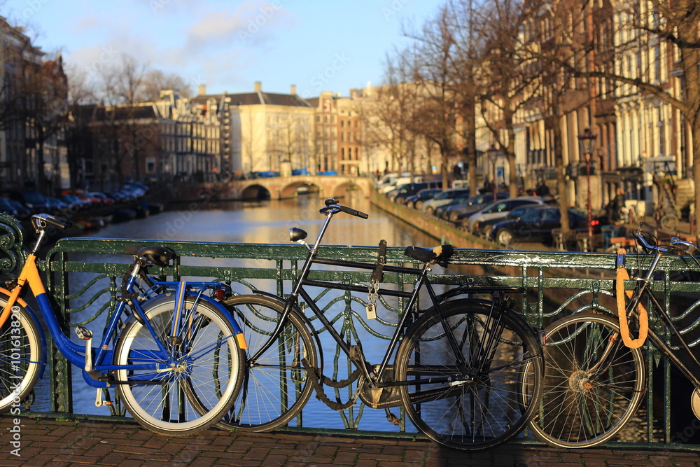 Bicycles lining a bridge over the canals of Amsterdam in the morning, Netherlands 