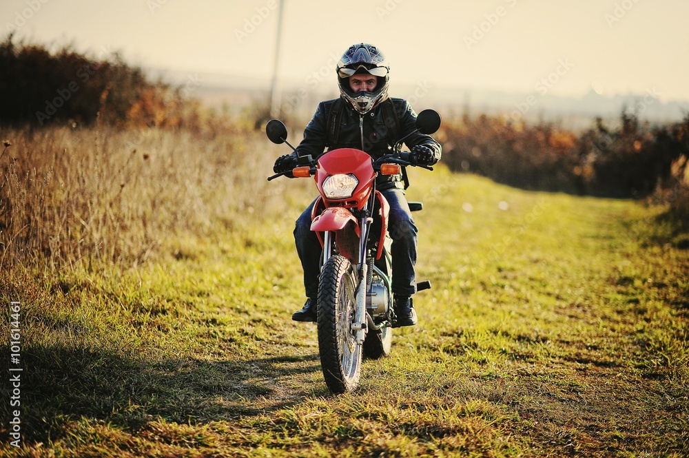 Enduro racer sitting on his motorcycle