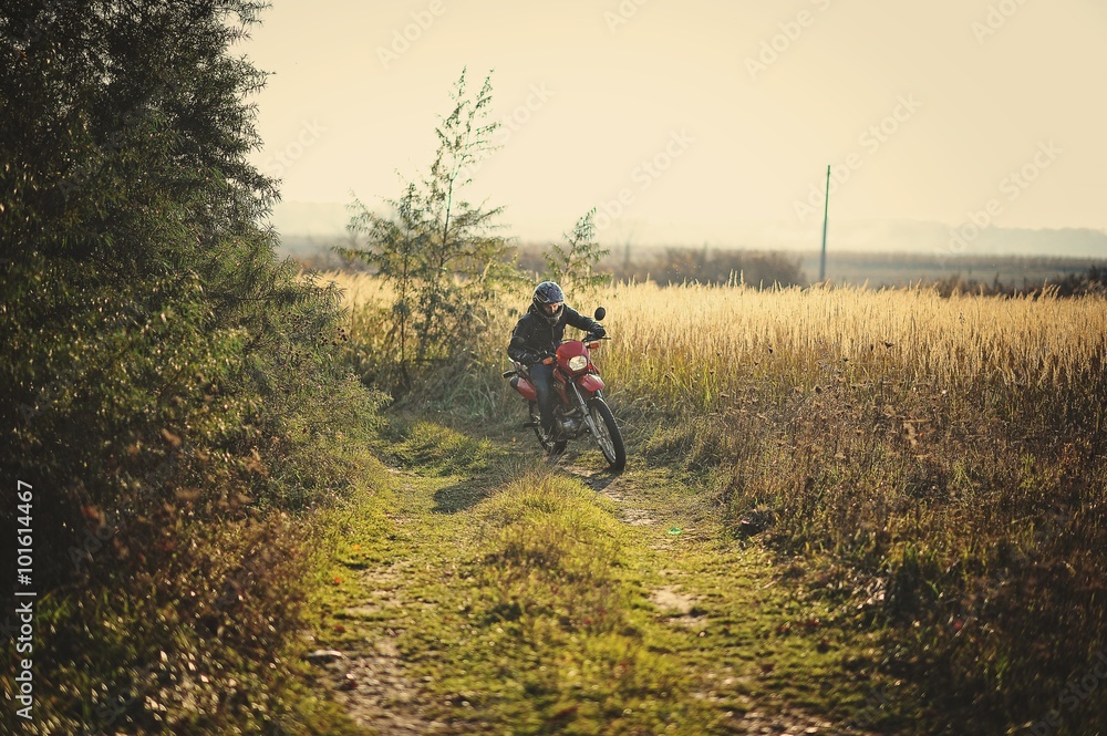 Enduro racer sitting on his motorcycle