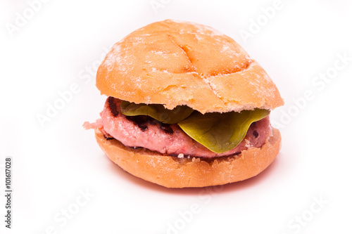 Grilled crocodile meat burger isolated on a white studio background.