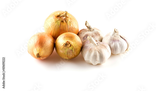 Raw whole onions and garlics on white