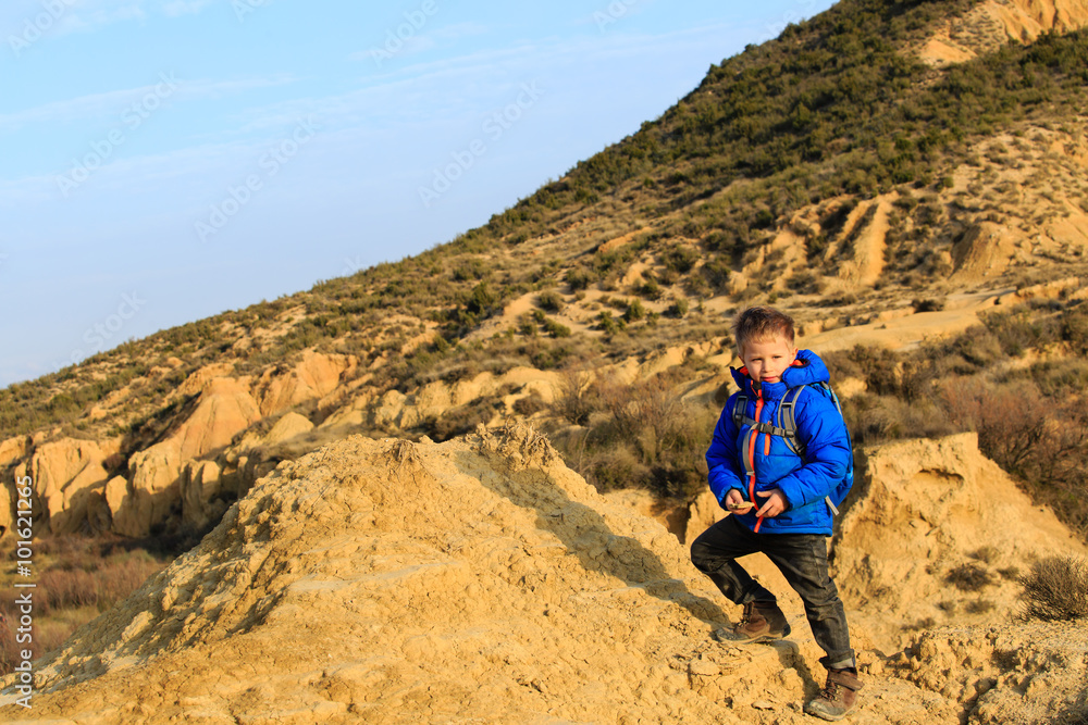 Fototapeta premium little boy with backpack travel in mountains