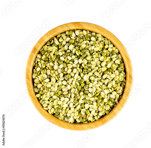 Aerial view of round bowl full of raw split mung bean lentils
