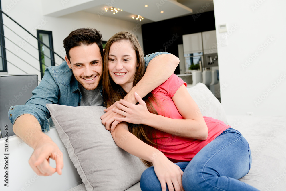 portrait of happy young couple together at home in sofa portrait of happy young couple together at home in sofa