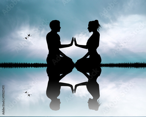 Photography couple doing yoga silhouette at sunset