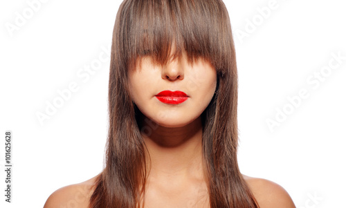 Portrait of female face with creative hairstyle with bang covering her eyes - long dark hair. Fashion makeup - classic red lips.