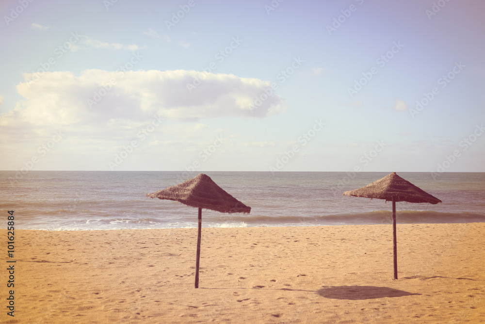 Exotic beach with palm tree umbrellas, golden sand, azure water Exotic beach with palm tree umbrellas, golden sand, azure water