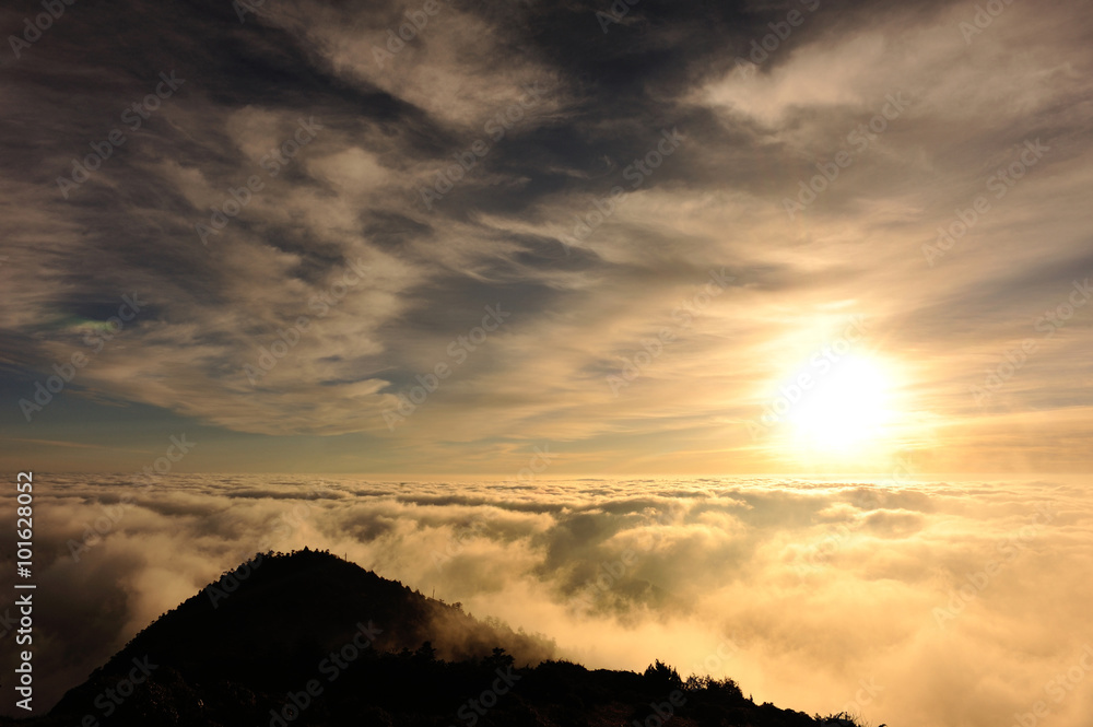 beautiful rolling clouds and sunrise on mountain summits landscape