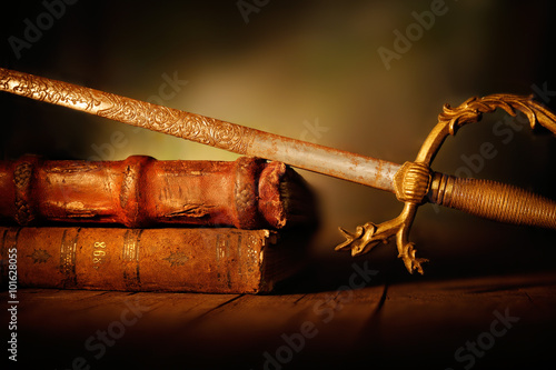 libri antichi con spada photo