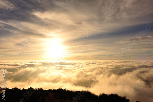 beautiful rolling clouds and sunrise on mountain summits landscape