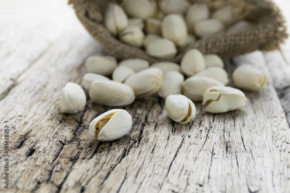 Pistachio nuts on wood background Pistachio nuts on wood background