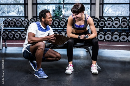 Fit woman discussing performance with trainer 