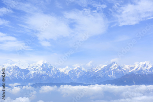 beautiful rolling clouds and frozen mountain summits sunrise landscape © lzf
