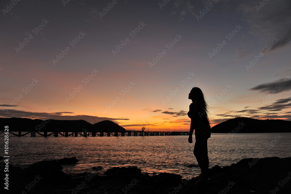 Fototapeta premium woman on beach in twilight