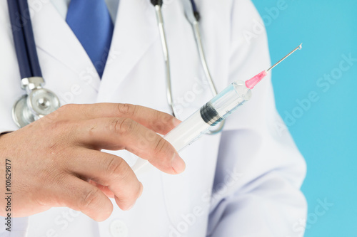 Doctor holding syringe ready for injection