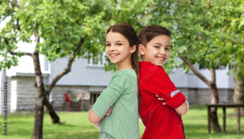 happy boy and girl standing together over backyard happy boy and girl standing together over backyard