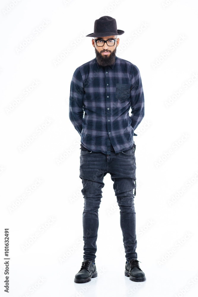 Attractive serious african american man standing with hands behind back Attractive serious african american man standing with hands behind back