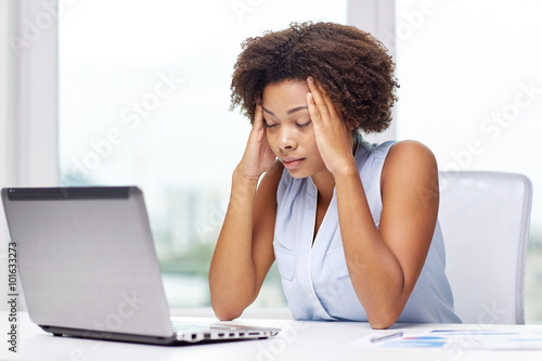 african woman with laptop at office