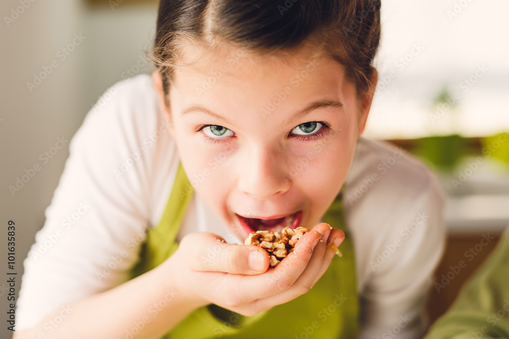 Funny Girl eating walnuts - Healthy eating concept Funny Girl eating walnuts - Healthy eating concept