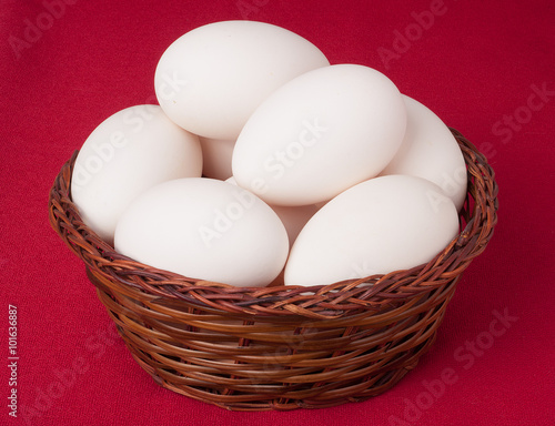 Wallpaper Mural eggs in a wicker basket on  red background Torontodigital.ca