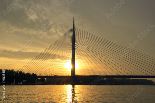 Cable bridge, named ADA BRIDGE, spanning the Sava river at dusk