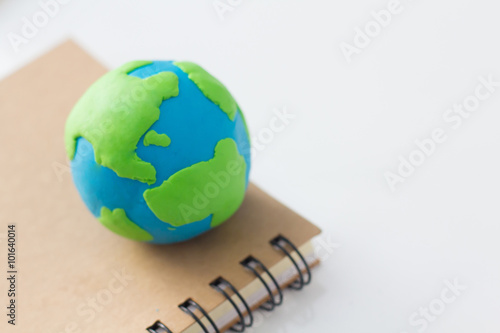 Earth on notebook on white background, Knowledge around the world.