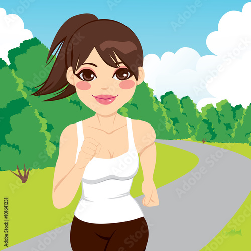 Beautiful happy young jogging woman running outdoors in park