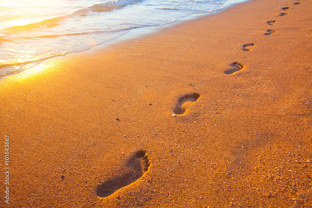 beach, wave and footprints at sunset time beach, wave and footprints at sunset time