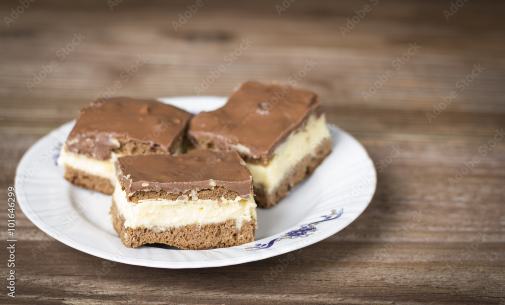 Chocolate cakes in a plate on wooden background