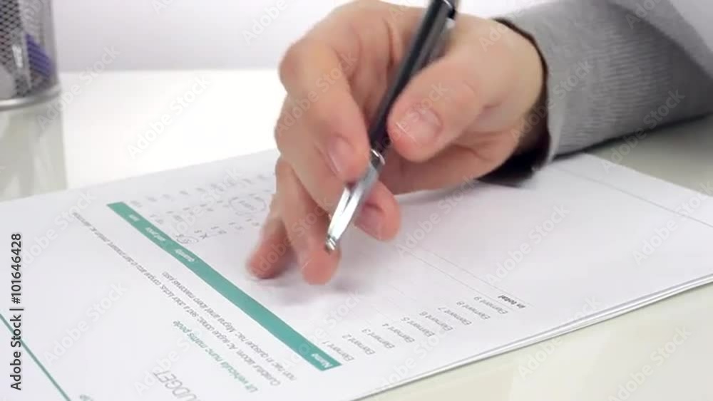 Businesswomen Analyzes Budget/Woman analyzes the document and makes notes. Close up Businesswomen Analyzes Budget/Woman analyzes the document and makes notes. Close up