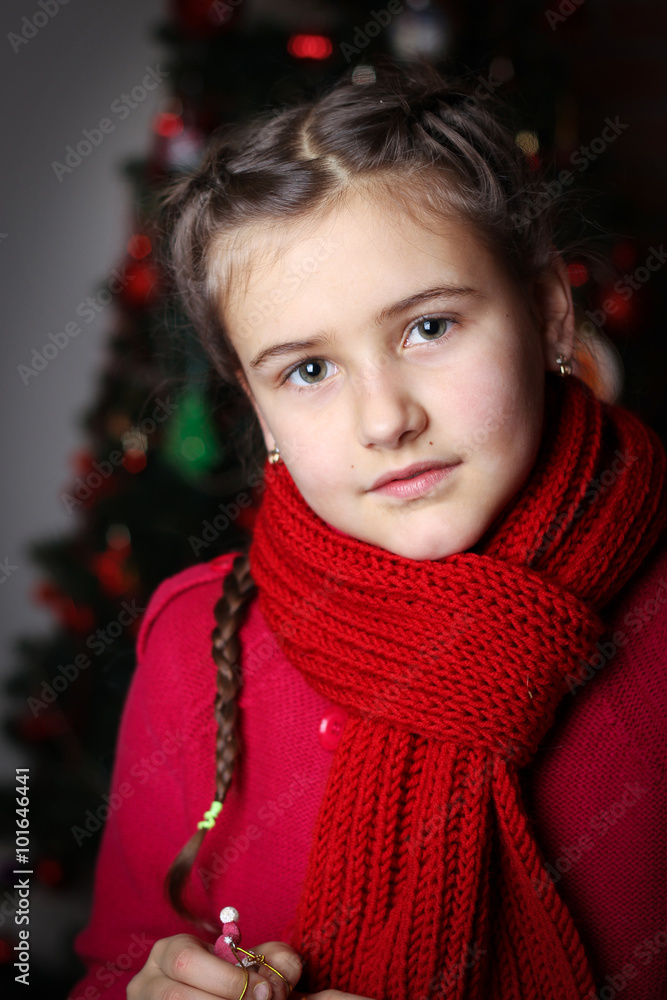 little girl with pigtails in red knitted sweater against the bac little girl with pigtails in red knitted sweater against the bac