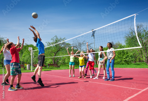 Jumping boy during volleyball game on the court © Sergey Novikov