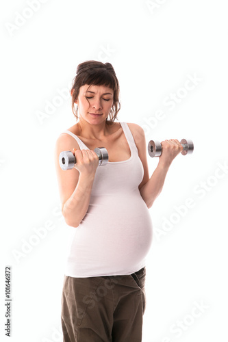 pregnant woman is engaged in gymnastics with dumbbells