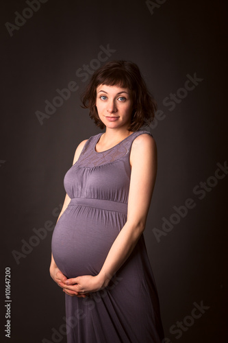 anticipation baby beautiful pregnant brunette woman in a gray dr