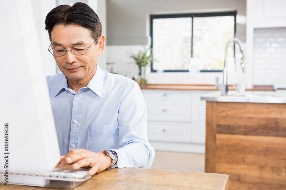 Smiling man using computer Smiling man using computer