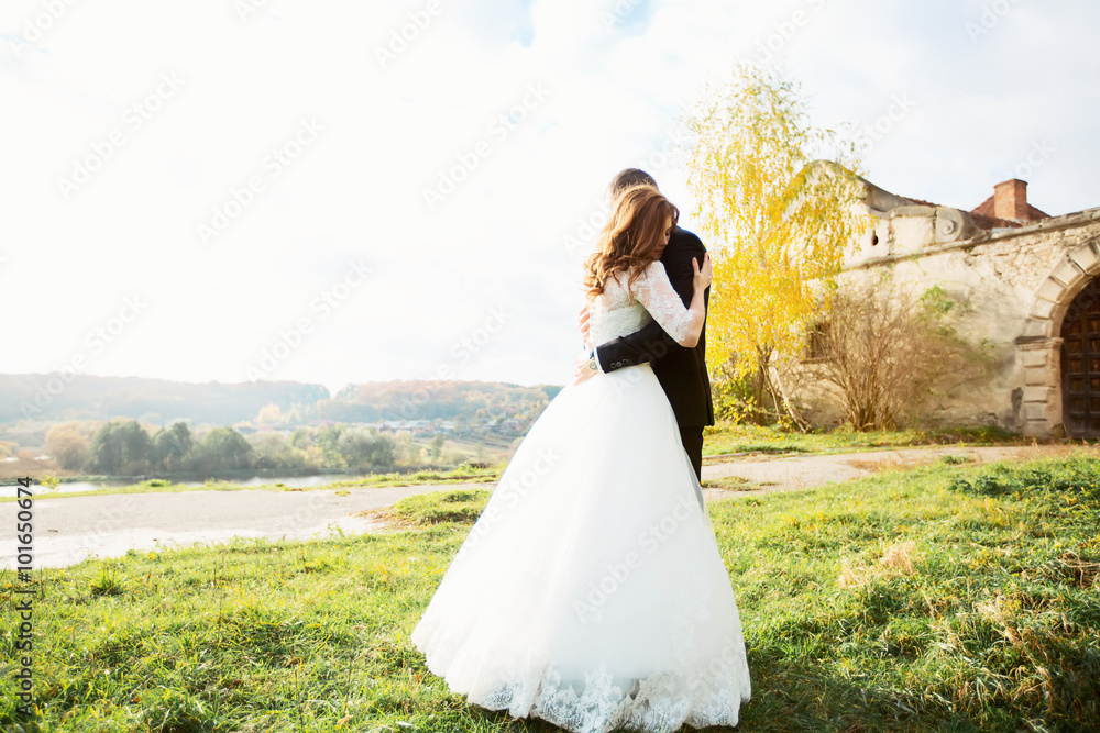 portrait of a girl and couples looking for a wedding dress, a pink dress flying with a wreath of flowers on her head on a background tsvetu chicago garden and the blue sky, and they hug and pose portrait of a girl and couples looking for a wedding dress, a pink dress flying with a wreath of flowers on her head on a background tsvetu chicago garden and the blue sky, and they hug and pose