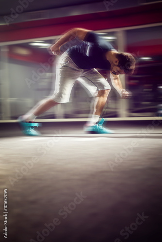 Running man with motion blur effect. Shallow depth of field.