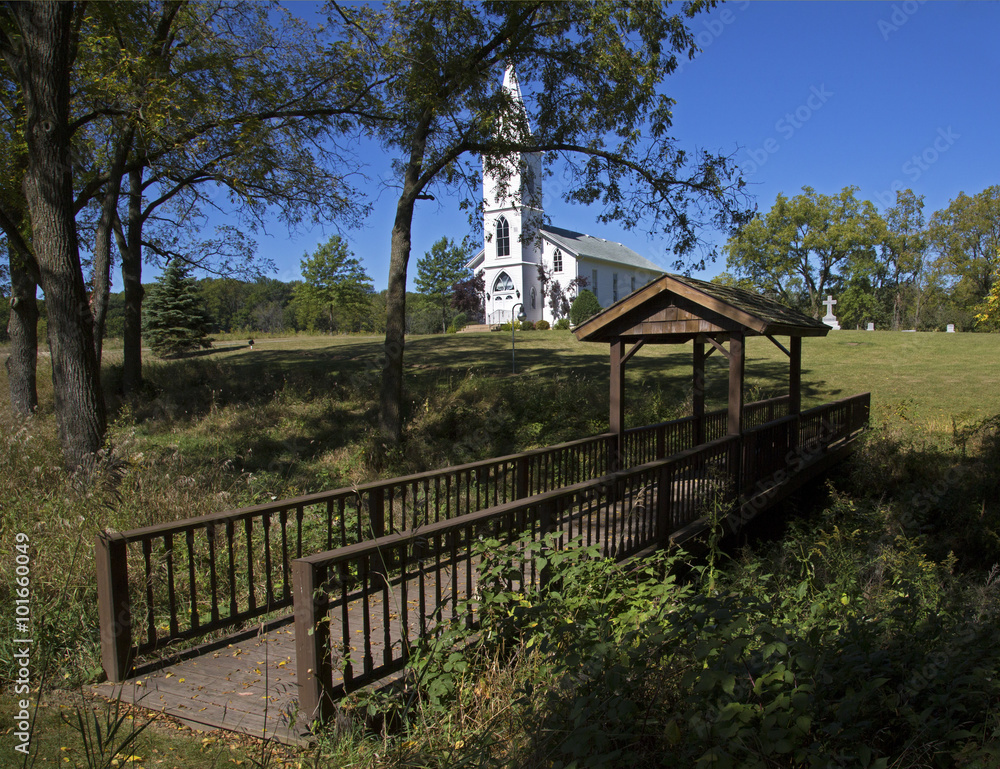 Rural white church  in a sunny meadow.