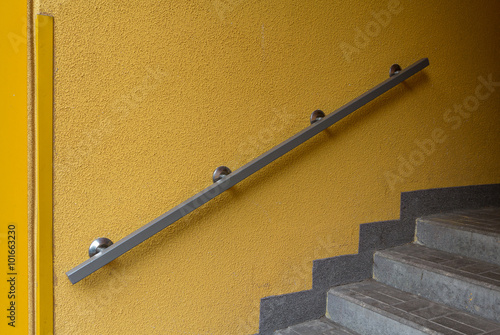 Metal railing on a yellow wall. Architecture