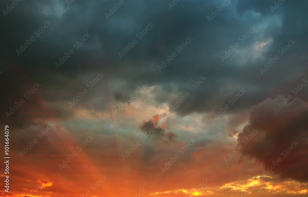 rays at sunset with storm clouds
