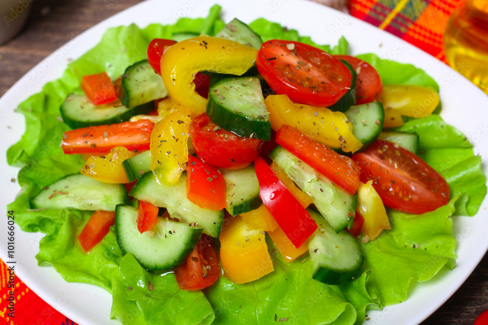 Helpful Fresh Salad of cucumbers, tomatoes, pepper and lettuce dressed with olive oil. Helpful Fresh Salad of cucumbers, tomatoes, pepper and lettuce dressed with olive oil.