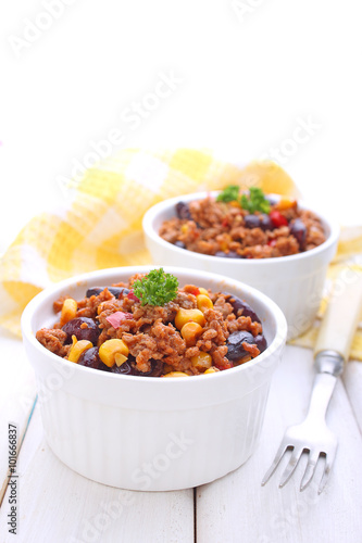 minced meat with corn, sweet peppers and beans in a dish