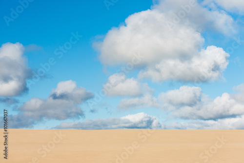 Giant sand dunes of Te Paki with clouds in a blues sky, New Zealand