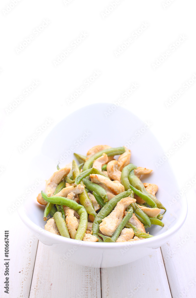 green beans with chicken and garlic in a white deep bowl green beans with chicken and garlic in a white deep bowl