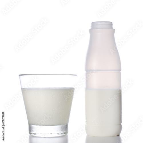 Glass of milk and bottle on white background.