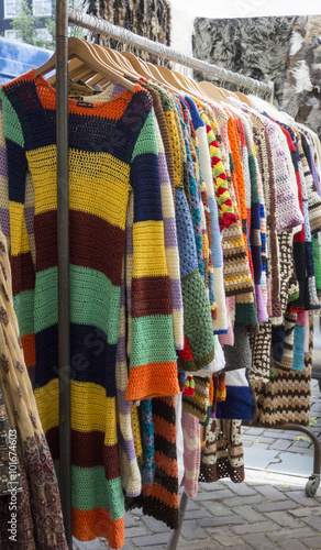 Crocheted Clothes Hanging on a Rail
